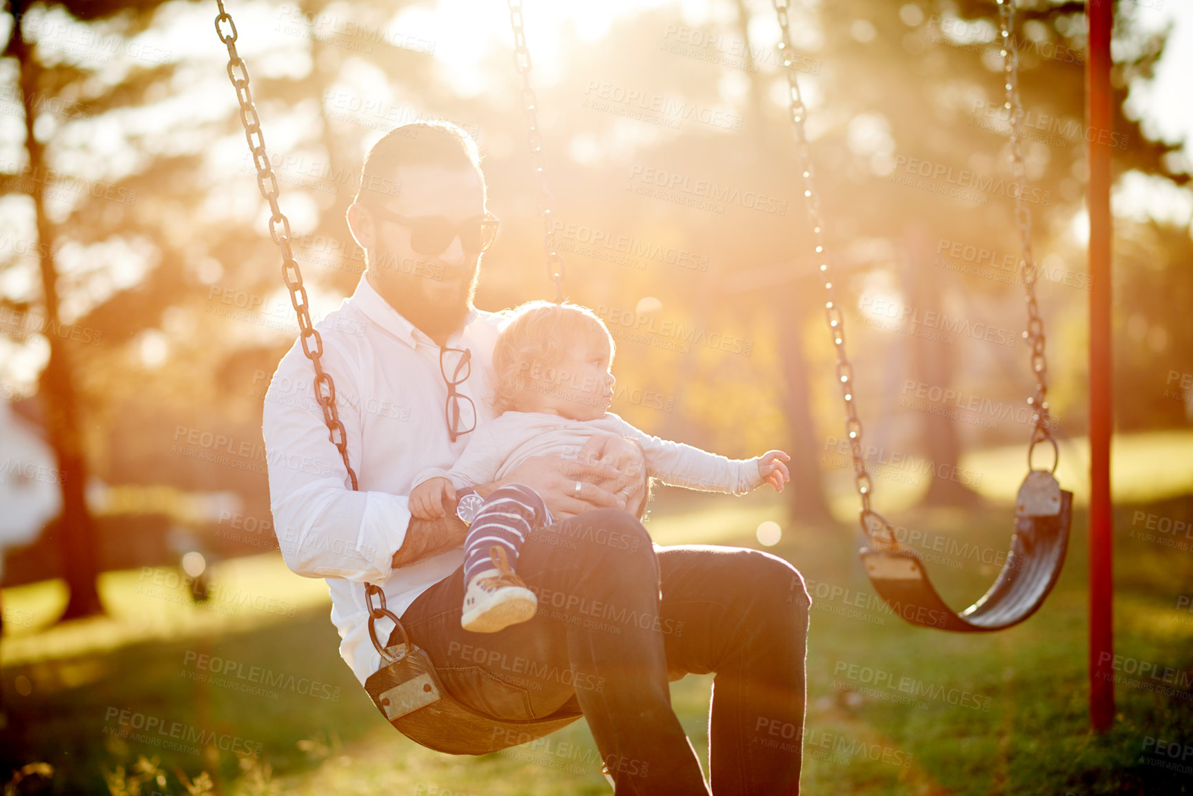 Buy stock photo Morning, swing and dad with girl in park with flare for playing, fun or bonding on weekend in nature. Happy, family or father with child on playground for relationship, holiday or development outdoor