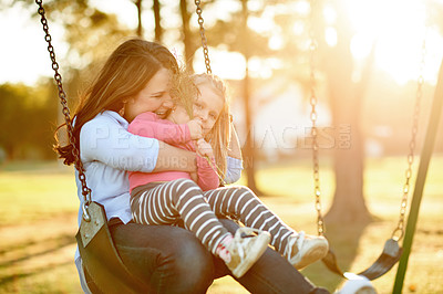 Buy stock photo Happy, mom and swing with child, playground or affection for toddler in nature or playing with girl. Outdoor, woman and fun with daughter on weekend, game and childcare on holiday, family and flare