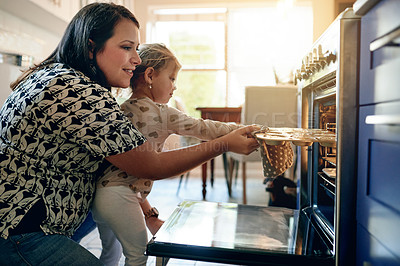 Buy stock photo Oven, baking and cupcake with mother and daughter in kitchen for help, cooking and learning. Support, food and teaching with woman and child in family home for dessert, bonding and love together