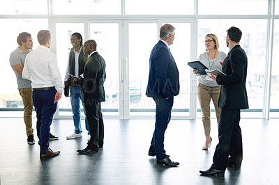 Buy stock photo Collaboration, meeting and discussion with business people in lobby of office for planning or strategy. Conversation, networking and teamwork with corporate employee group in workplace for conference