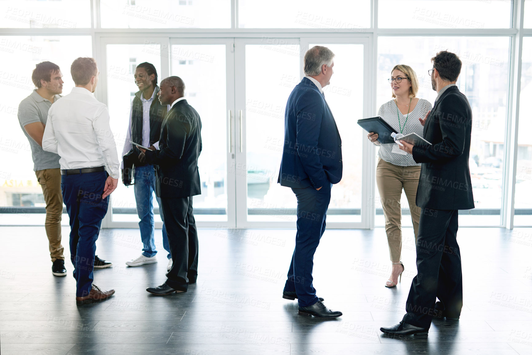 Buy stock photo Collaboration, meeting and discussion with business people in lobby of office for planning or strategy. Conversation, networking and teamwork with corporate employee group in workplace for conference