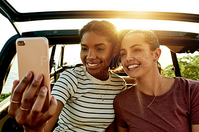 Buy stock photo Road trip, happy and selfie of women by car for travel memory on vacation, adventure and journey in nature. Friends, flare and people with photo, profile picture and smile for social media post