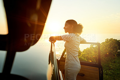 Buy stock photo Sunrise, happy and woman by car for road trip, adventure and travel destination by ocean. Morning, relax and person by vehicle for holiday, summer vacation and journey in countryside by coastline
