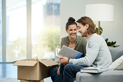 Buy stock photo Boxes, book and couple on sofa, unpacking and homeowner with relationship, relocation and relax. Rental apartment, happy man and woman with literature and excited with novel, love and real estate