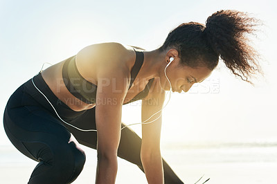 Buy stock photo Stretching, beach and woman with fitness, breathing and training with wellness, workout and earphones. Cardio, ocean and person with exercise, healthy and seaside with sound, ready or warm up routine