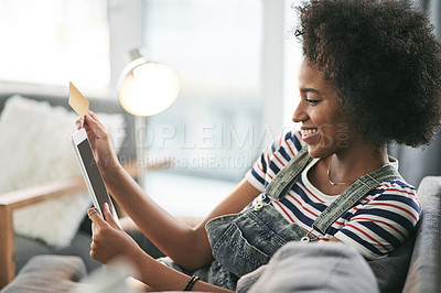 Buy stock photo Online shopping, woman and tablet for purchase, lounge and credit for sale on website, rest or home. Happy, customer and African person with card for payment, bills or transaction with tech in house