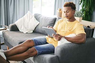 Buy stock photo Home, thinking and black man on sofa, tablet and typing with online reading, solution and app. Apartment, tech and African person on couch, internet and planning with decision, social media or choice