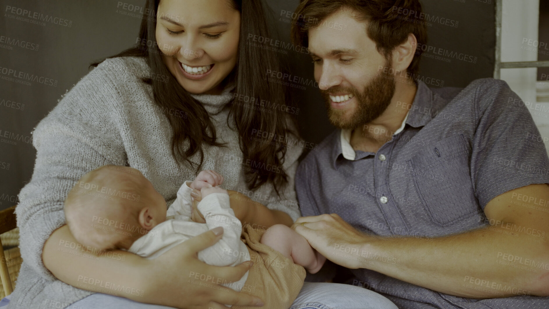 Buy stock photo Mother, father and baby on a sofa to relax in the living room of their home together for love, care or bonding. Family, smile or happy with parents holding their cute newborn infant chid in a house