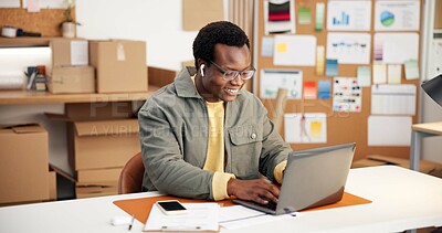 Buy stock photo Black man, laptop and happy in small business for logistics, order management and streaming audio. Entrepreneur, earphones and tech in office for inventory control, website update and email response