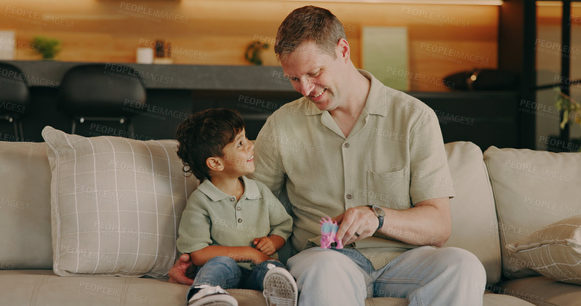 Buy stock photo Family, dad and child with toy in house, fun and bonding with boy on break and laughing together. Cognitive development, home and happy man with kid in living room, connection or play with dinosaur