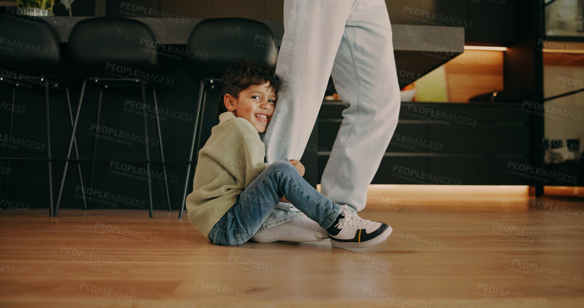 Buy stock photo Child, person and clingy in home with legs, playful and dragging game for relationship development. Boy, parent and family in living room with trust, bonding and smile for attachment and security