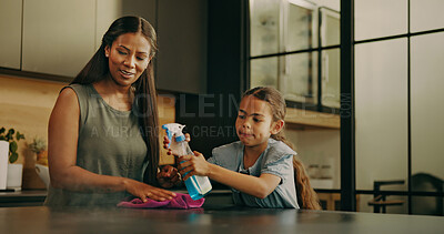 Buy stock photo Mom, child and spray for cleaning, learning and teaching domestic duties with parenting in home. Hygiene, disinfect and mother guiding girl with detergent, wiping counter or help with kitchen routine