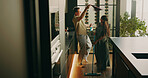 Happy, couple and cleaning in kitchen with dance, feel good energy and maintenance for hygiene. People, interracial marriage and fun movement in home with household chores, productivity and bonding.