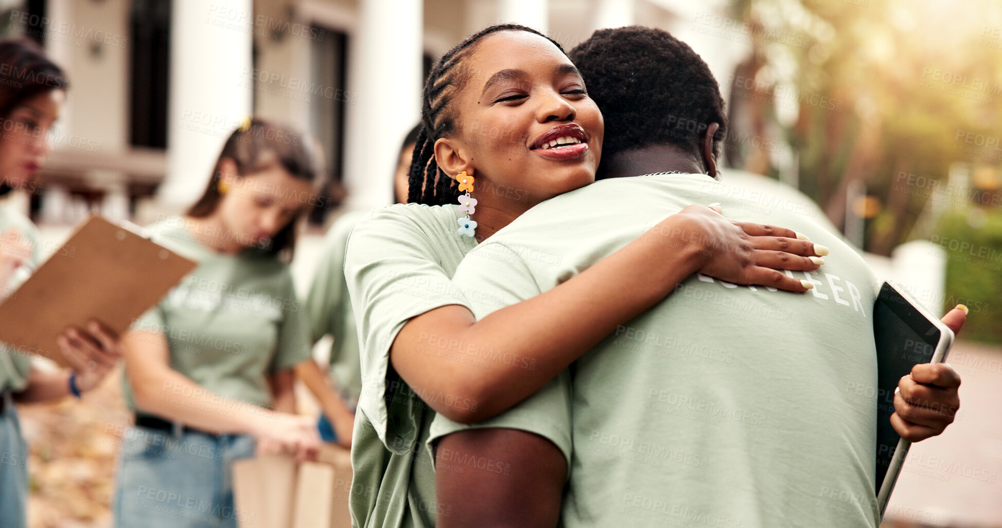 Buy stock photo Smile, woman and hug outdoor for volunteering, gratitude and thank you for community service. Happy, people and embrace with tablet for appreciation, recognition and team success of welfare project