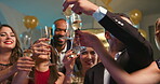 Young diverse friend group holding glasses toasting at party