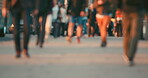 Crowd of blurred people walking through a city together