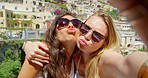 Two women pouting while taking selfies together on holiday