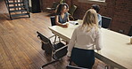 a group of businesspeople having a meeting in a modern office. Diverse group of businesspeople in an office sitting at a table to have a meeting and collaborate and brainstorm. Businesspeople talking