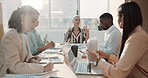 Diverse group of businesspeople passing paperwork during meeting in office boardroom. Ambitious colleagues analysing reports and documents while planning and brainstorming strategies in startup agency