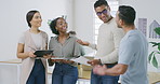 Four happy diverse businesspeople having a meeting together at work. Young businessman greeting colleagues before arriving at a meeting in an office. Business professionals planning and brainstorming