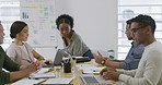 Diverse group of five businesspeople in a meeting in the office. African american businesswoman arriving in a boardroom with her colleagues. Business professionals planning together