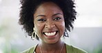 Closeup portrait of one confident african american woman smiling while standing at a restaurant. Face of a joyful black female with an afro looking cheerful standing against a blurred background