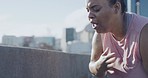 Exhausted unfit woman breathing heavily and hitting her chest during a run along city highway in outdoor workout. Sweaty plus size woman starting weight loss journey