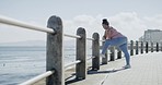 One plus size overweight woman stretching legs to prevent injury for warmup exercise before run on promenade outdoors. Chubby obese woman ready for cardio training to reach healthy weightloss goal