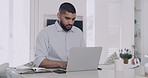 Mixed race businessman looking contemplative, using laptop and reading paperwork in home office. Hispanic entrepreneur thinking of solution idea and working on startup. Focused and planning strategy