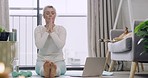 Woman watching yoga class on laptop, following practice and stretching in home zen lesson. Mature yogi sitting on living room floor, finding inner mental health balance or peace in holistic exercise