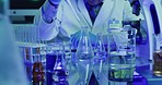 Laboratory scientist using dropper or pipette and glass beaker to test chemical reaction ultraviolet lit lab. Biochemist doctor wearing protective surgical gloves, experimenting and swirling solution