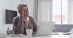 Upset gray haired senior woman looking at laptop screen sitting at desk in living room. Frustrated mature businesswoman made mistake in work, has issues with project. Stressing working from home