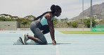 Strong sportswoman runs with speed and strength, professional endurance training for a marathon race. Fast athletic woman running on tracks at a stadium. Female runner at the starting block sprinting