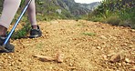 Diverse group of mountain hikers walking and using trekking poles alone hill trail or path. Friend clique bonding on social hike in remote area landscape. Man and women backpacking in serene nature