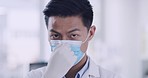 A closeup view of a professional doctor pulling a Respiratory Mask and Putting on a face. Senior medical man putting on a safety mask inside the hospital for protection from COVID-19 pandemic. 
