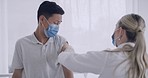 Doctor injecting covid vaccine into patient's arm during a hospital clinic consult. Man wearing a mask, feeling nervous or anxious to receive a coronavirus vaccination with a syringe by a medical gp