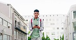 Teenage boy texting on phone and walking in a city. Young, hip, cool and fashionable teen browsing social media, networking and searching the internet. A smiling student playing games on technology