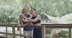 Laughing athletes using phone to take selfies for social media. Smiling man and woman feeling happy after a finished workout training exercise in nature park. Fit, athletic friends bonding in woods