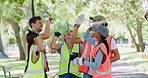 Group of volunteers high five after cleaning the park. Cheerful council workers or activist cheering after a job well done recycling and making outside a cleaner and greener environment