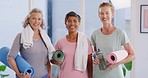 Group of senior yoga woman holding exercise mats and water bottles while working out. Portrait of three mature females exercising in a pilates class and staying fit and active during retirement