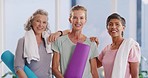 Active mature women ready for a yoga session in a fitness studio. Portrait of a diverse group of confident and smiling ladies feeling cheerful, content and excited to enjoy a relaxing workout class
