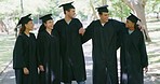 Group of university students hugging while celebrating their graduation ceremony together. Portrait of excited and proud friends feeling cheerful and happy for their accomplishment and achievement