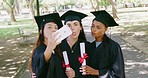 Group of graduates using a phone for social media selfies after graduation ceremony on university campus. Diverse women and friends using technology and holding degrees after graduating from college