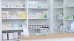 Blurred view of stocked pharmacy shelves in a chemist or hospital with copyspace. Pharmacy and healthcare industry background for treating patients. Prescription and over the counter service