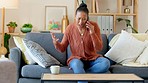 Angry and upset woman talking on the phone and having an argument with her boyfriend or service provider. Young African female on a call and looking stressed after breakup or getting bad news at home