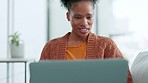 Woman online shopping on laptop in home living room and browsing variety of options during lockdown. Smiling, relaxed and happy woman using technology to blog, trade or study distance learning course