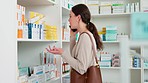 Woman talking on a call to find out about a medication she needs from a pharmacy. Young female having a conversation with loved one or doctor for advice on medicine to cure an illness at a drugstore