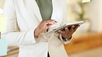 Business woman typing on a touchscreen tablet. Closeup of a fashion designer checking website design and analyzing digital files. Trendy entrepreneurs looking at social media and website analytics