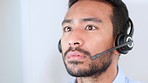 closeup of the face of a young call center agent talking to clients and answering their questions online. One male customer service worker giving advice to people and helping them with retail issues