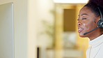 Female call center agent talking on headset and looking at her computer screen while explaining information. Friendly saleswoman consulting and operating a helpdesk for customer service and support
